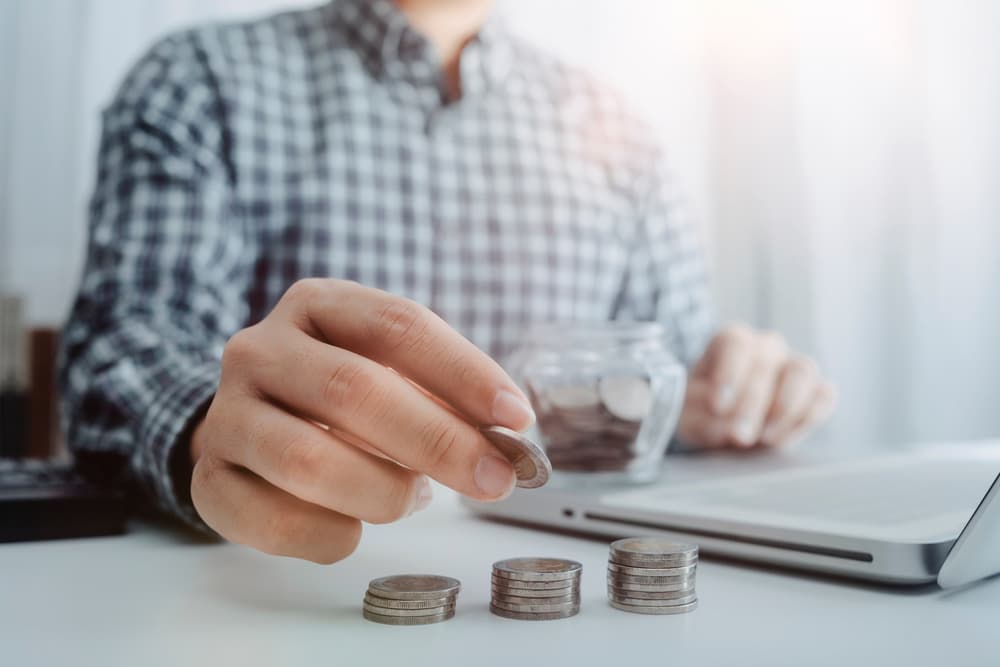 Doctor calculates healthcare costs using a calculator in modern hospital - healthcare expenses concept
